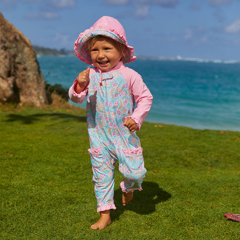 Little girl in UV Skinz's baby girl's reversible sun hat in fruit fiesta|fruit-fiesta