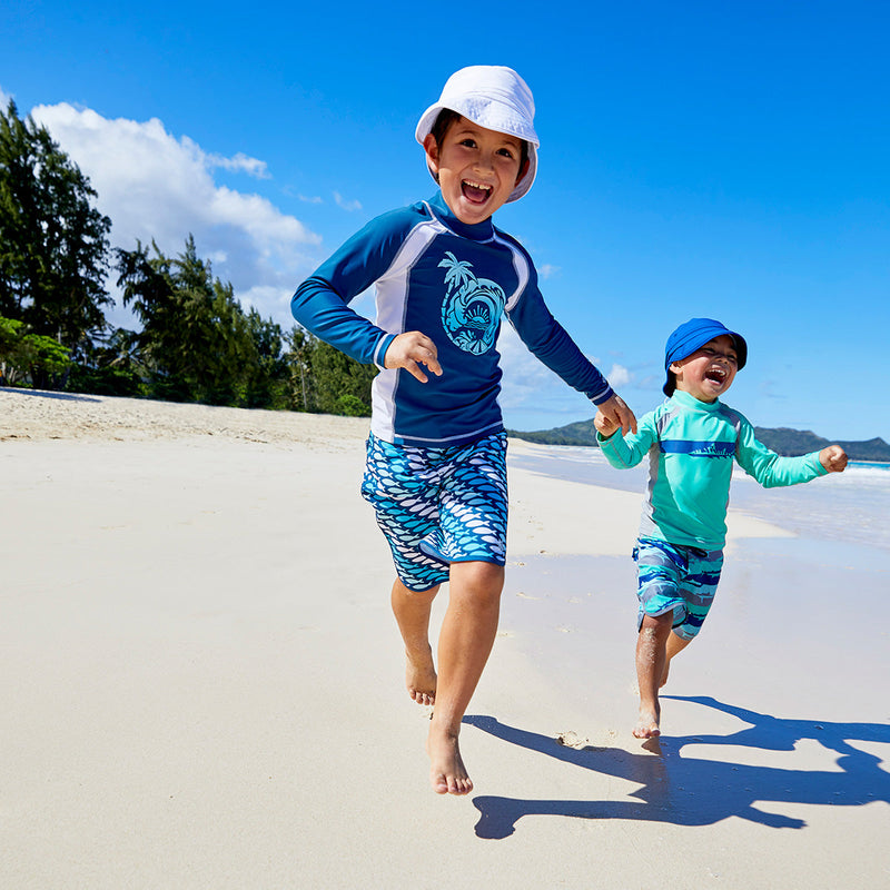 Little boy wearing UV Skinz's boy's long sleeve active swim shirt in mint tiger shark|mint-tiger-shark