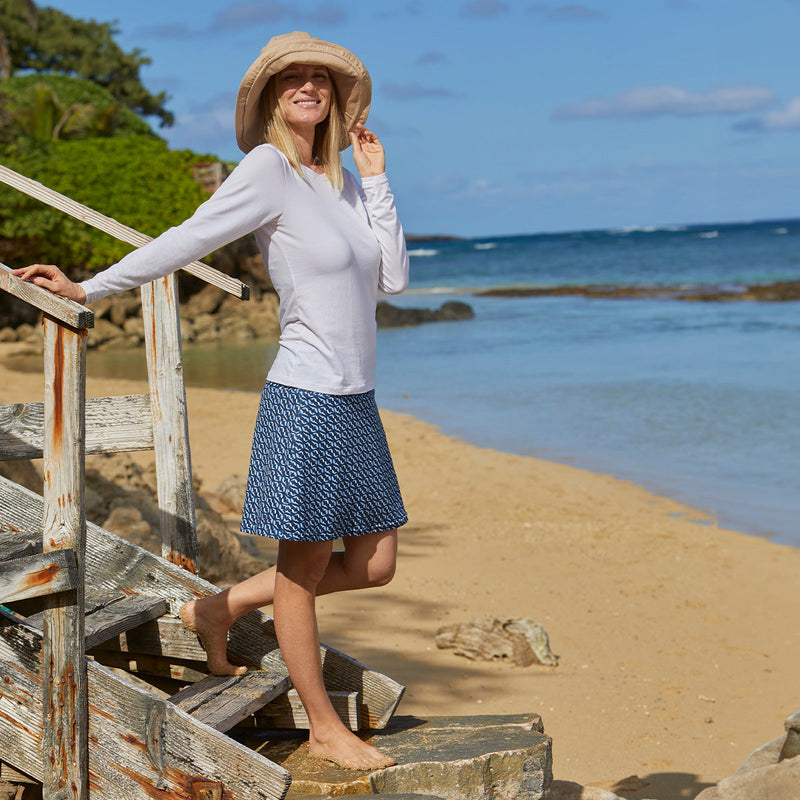 Woman on the beach in UV Skinz's Women's Travel Skort in serenity fish|mini-turtles